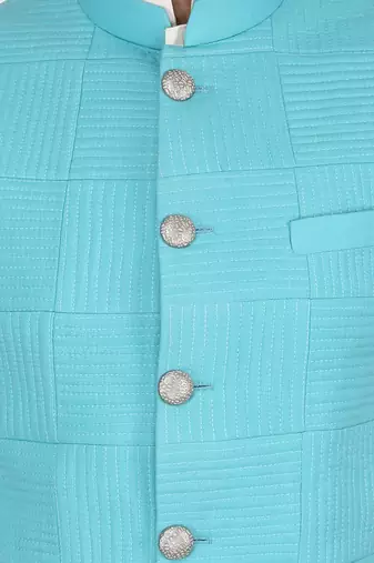 Featuring Turquoise blue qulited nehru jacket with kurta & churidaar.