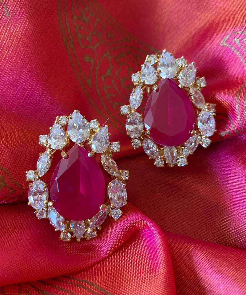 Red Pear Shaped Ruby Stud With Different Shaped Diamond Halo In 18K Gold Polish
