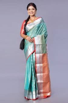 Kanjivaram silk saree in forest green color with silver zari motifs