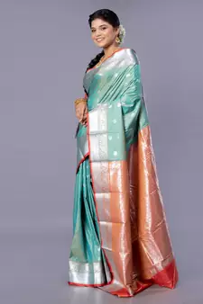 Kanjivaram silk saree in forest green color with silver zari motifs