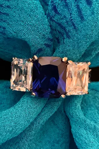 Blue Sapphire Center With Emerald Cut Diamonds On Either Side