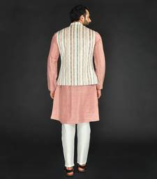 Off White Imported Russian Printed Bundi With Vis. Silk Peach Kurta Paired With Off White Spun Silk Chudidar.