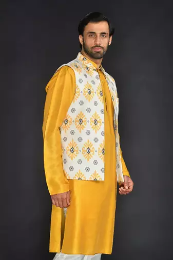 Off White Poly. Khadi Textured Printed Bundi With Musterd Vis. Silk Kurta Paired With Off White Spun Cotton Chudidar.