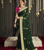 Dark green embroidered silk saree with blouse