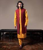 Honey Yellow Thin Pleats Kurta And Churidar With Maroon Embroidered Jacket.
