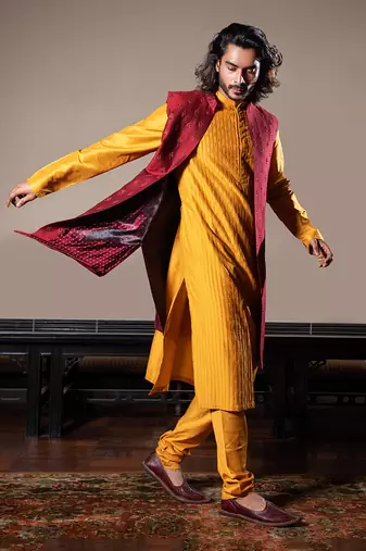 Honey Yellow Thin Pleats Kurta And Churidar With Maroon Embroidered Jacket.