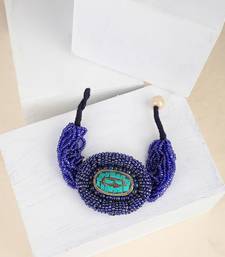 Contemporary Blue colored Beads studded Oval shaped Bracelet for Women and Girls.