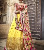 YELLOW & RED SEQUINS AND THREAD EMBROIDERED SOFT NET FESTIVE & PARTY WEAR SEMI STITCHED BRIDAL LEHENGA