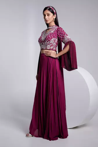 A Fllawless V Neckline Crop Top Emrbiodered Uniquely. The Sleeve Has Cut Flare Details. The Skirt Is Pre Draped.
