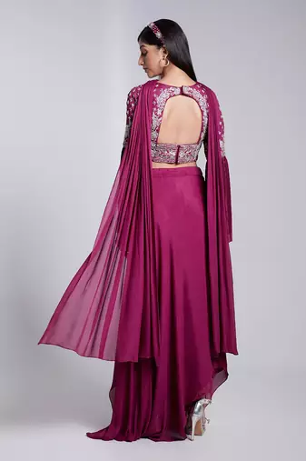 A Fllawless V Neckline Crop Top Emrbiodered Uniquely. The Sleeve Has Cut Flare Details. The Skirt Is Pre Draped.