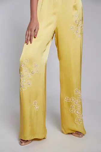 Jumpsuit With One Shoulder Ruffle Details The Pants Have Hand Embroidery