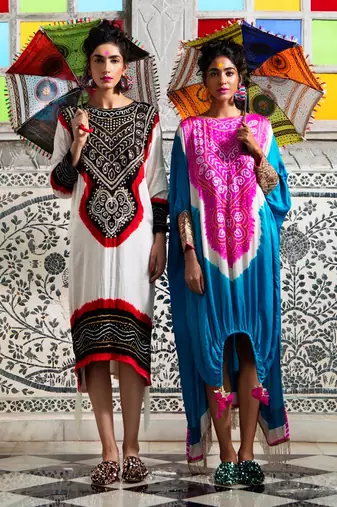 White gajji silk kaftan with gota and mirror embellished neck, tassels at the hem.