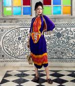 Purple and orange jumpsuit with cape jacket highlighted with gold and gota tassels.