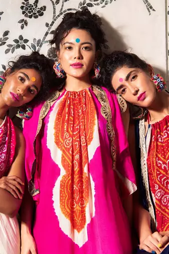 Fuchsia and orange gajji silk jumpsuit with bandhani patterns and jacket with pita work.