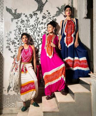 Cream and fuchsia gajji silk dhoti with halter blouse embellished with gota tassels. 2