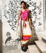 Cream and fuchsia gajji silk dhoti with halter blouse embellished with gota tassels.