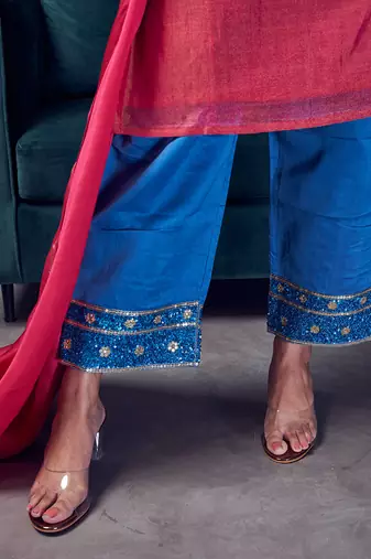 Pink coloured chanderi tissue kurta & sky blue coloured silk pant & dupatta with heavy sequense embroidery