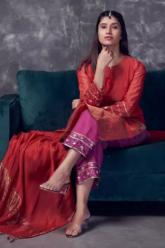 Red coloured chanderi tissue kurta & magenta coloured silk pant & dupatta with heavy sequense embroidery