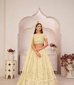 Light-yellow embroidered
 net semi stitched lehenga