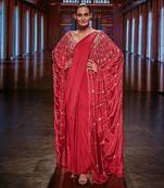 crimson saree with a blouse and a cape