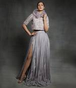 Featuring a dull lilac slit skirt with embroidered  jacket and ruffle neck