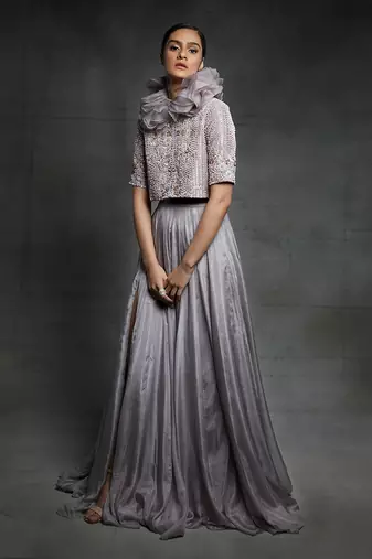 Featuring a dull lilac slit skirt with embroidered  jacket and ruffle neck