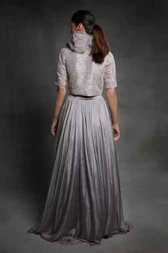 Featuring a dull lilac slit skirt with embroidered  jacket and ruffle neck
