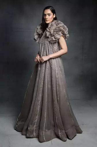Featuring a chickoo embroidered trapeze gown with a ruffle jacket