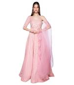 Featuring a grey gown in dupion base with rose gold resham 3D embroidery. It is paired with a matching cape in net base.