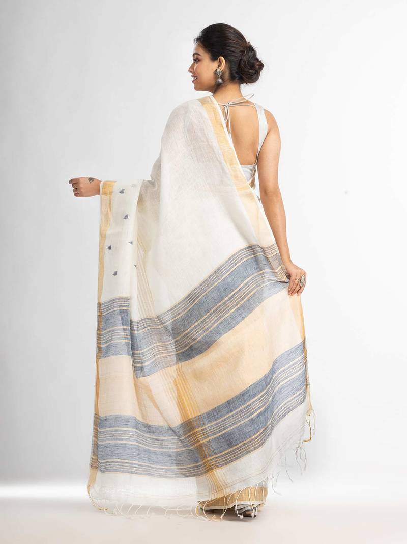 white half body buti with gold zari and nevy blue pallu in gold zari border handwoven linen saree