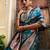 Janasya rashmika x saji saheli - women's teal green banarasi silk woven floral design saree with unstitched blouse piece