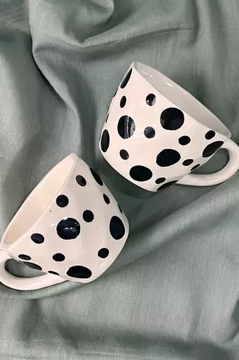 Whimsical Delight: Handmade Ceramic Mug  with Contrasting Black Polka Dots on Ivory-White Background