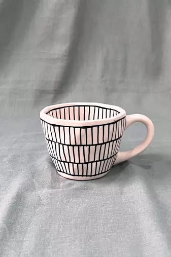 Urban Chic: Handcrafted Ceramic Mug with Brick Design Inside and Outside in Black on Ivory-White Background