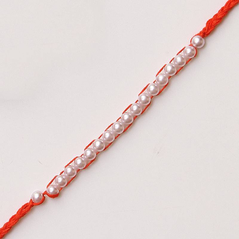 C-Knits crochet handmade white perals traditional rakhi-orange with complimentary glitter thread