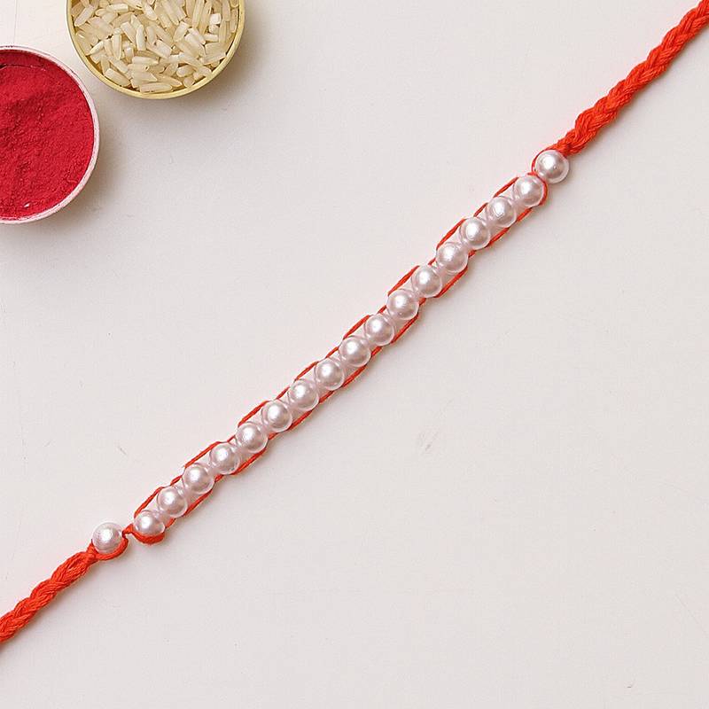 C-Knits crochet handmade white perals traditional rakhi-orange with complimentary glitter thread