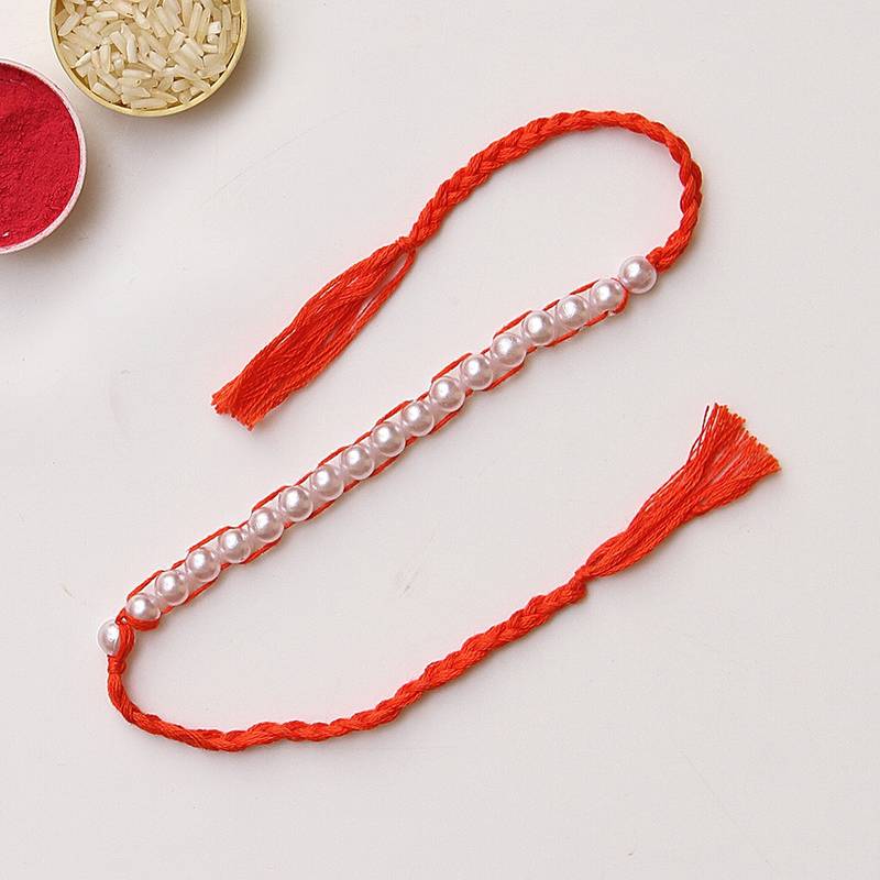 C-Knits crochet handmade white perals traditional rakhi-orange with complimentary glitter thread
