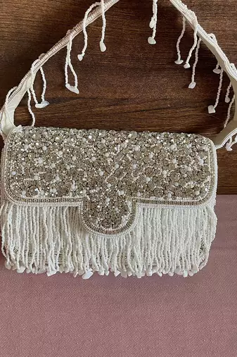 White & silver studded tassel bucket bag