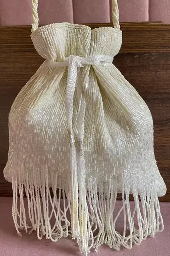 White dangling tassel embellished potli bag