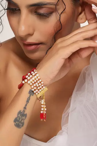 Red and white gold tone pearl bracelet