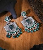 Oxidised green stone-studded pearl-tessels earrings