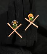 Gold-plated green stone-studded cross design earrings