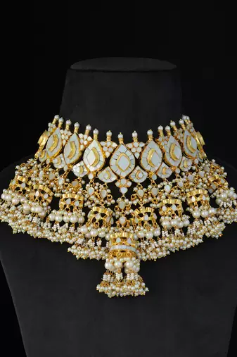 Gold finish kundan and mother of pearls necklace set