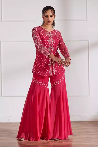 Fuscia net peplum with bustier and gharara