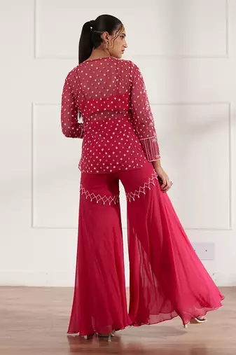 Fuscia net peplum with bustier and gharara