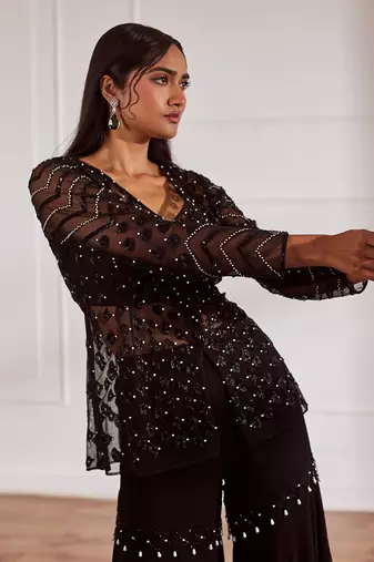 Black net peplum with bustier and gharara