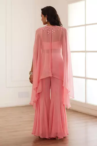 Peachish pink croptop and sharara and cape.