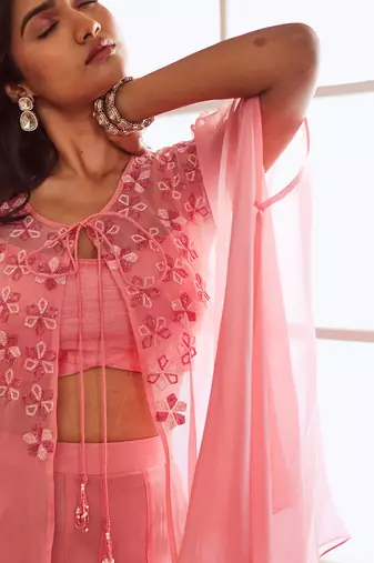 Peachish pink croptop and sharara and cape.