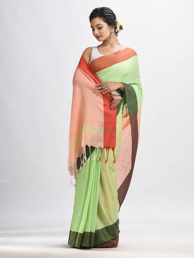 Light green cotton with solid body in tawny peach pallu handloom saree