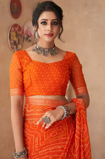 Orange printed chiffon bandhani saree with blouse