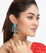 Women silver plated green stone-studded peacock shaped jhumka